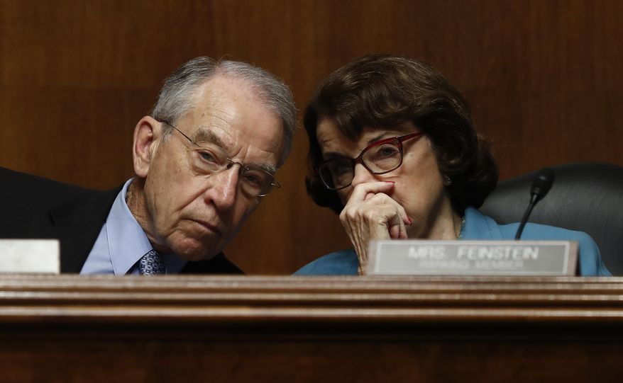 FILE - In this May 3, 2017 file photo, Senate Judiciary Committee Chairman Sen. Charles Grassley, R-Iowa talks with the committee's ranking member Sen. Dianne Feinstein, D-Calif. on Capitol Hill in Washington. Feinstein has said publicly that the FBI paid $900,000 to break into an iPhone of one of the San Bernardino, California, shooters. (AP Photo/Carolyn Kaster, File)