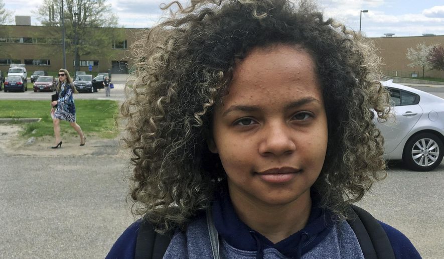 In this Wednesday, May 3, 2017 photo, Allyanna Jones stands outside Wilby High School in Waterbury, Conn. The 16-year-old junior was among more than 150 students suspended for dress code violations on April 21. The crackdown has brought attention to high suspension rates in the district. (AP Photo/Michael Melia)