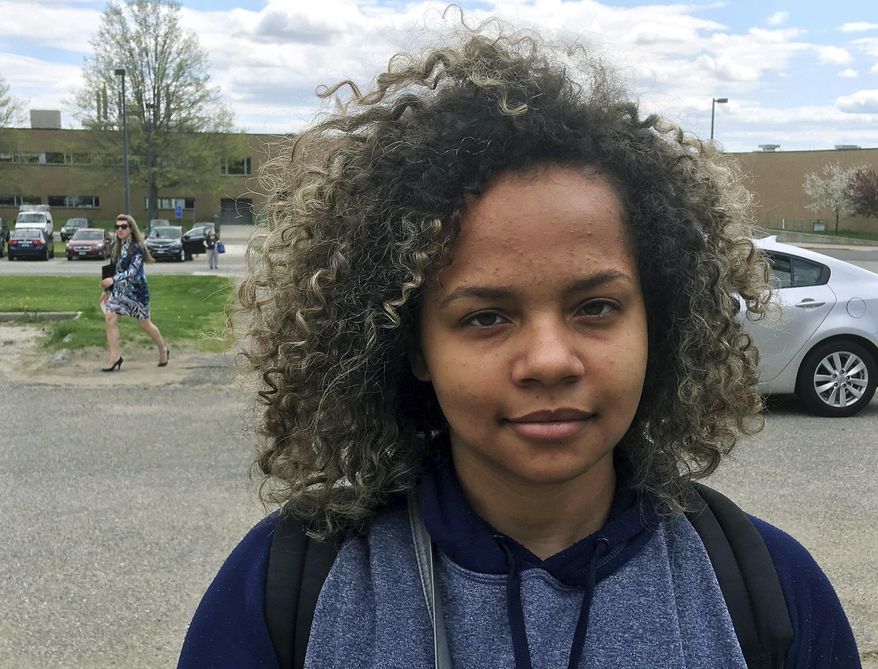 In this Wednesday, May 3, 2017 photo, Allyanna Jones stands outside Wilby High School in Waterbury, Conn. The 16-year-old junior was among more than 150 students suspended for dress code violations on April 21. The crackdown has brought attention to high suspension rates in the district. (AP Photo/Michael Melia)