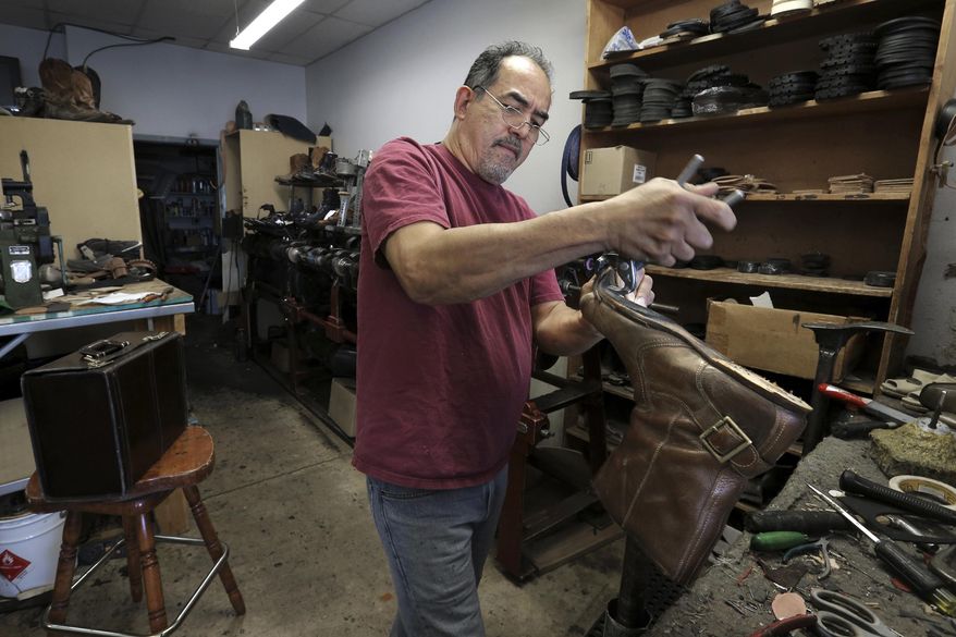 ADVANCE FOR MONDAY MAY 8, 2017- This photo taken April 7, 2017, shows modern day cobbler Javier Rodriguez repairing a pair of boots for a client out of Memphis at his east El Paso shoe repair shop. Rodriguez's family has a long history of shoe repair in the El Paso area. (Mark Lambie/The El Paso Times via AP)