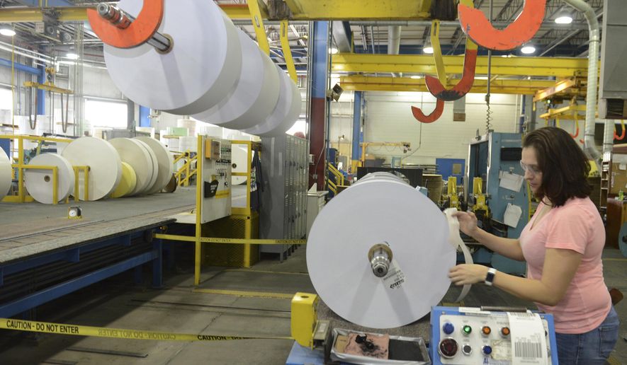 ADVANCE FOR SATURDAY, MAY 6, AND THEREAFTER – Dawn Varner, of Roaring Spring, Pa., labels rolls of paper April 27, 2017, at the Appvion Inc. paper mill in Roaring Spring, Pa. When the mill&#x27;s France-based owners announced plans to sell their American subsidiary in 2001, employees nationwide pitched in to take control of the company by forming a worker-owned corporation now called Appvion Inc. During the Rust Belt&#x27;s decades long manufacturing decline, cities have often managed to claw their way back to a growing economy, while towns with just one or two employers can remain desolate for decades. (Gary M. Baranec/Altoona Mirror via AP)