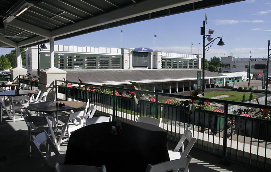 In this Tuesday, May 2, 2017 photo, the Champions Lounge outdoor seating area, part of the ongoing renovations at Churchill Downs, provides an impressive view of the paddock and the walking ring at Churchill Downs in Louisville, Ky. Churchill Downs' parent company has pumped $250 million into renovations since the early 2000s. But many have catered to well-heeled fans willing to shell out thousands of dollars for panoramic views, sumptuous buffets, access to betting windows and restrooms without lines, and demand outpaces available seating. That's leaving the middle class squeezed out. (AP Photo/Garry Jones)