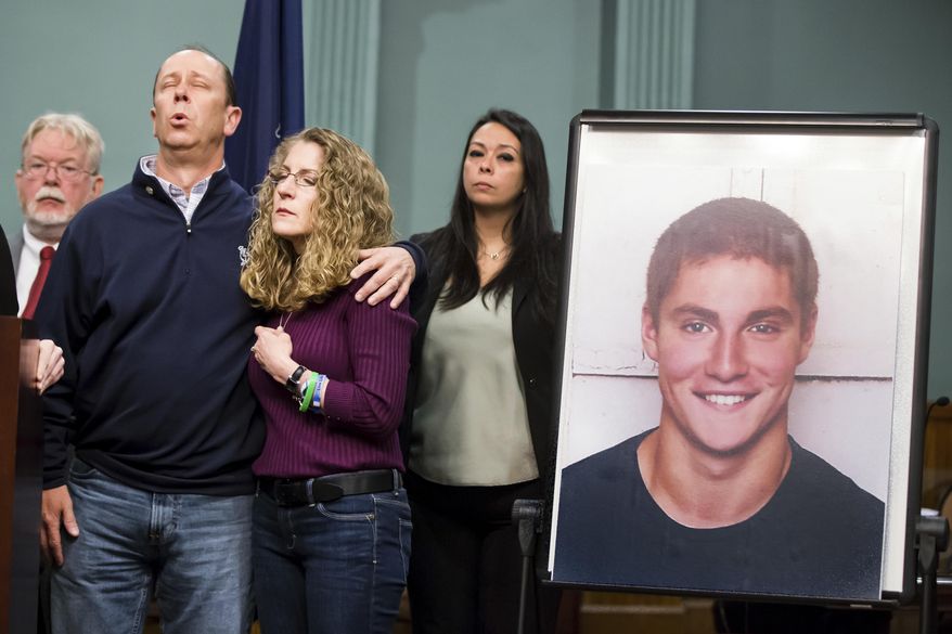 Jim and Evelyn Piazza stand by as Centre County District Attorney Stacy Parks Miller announces the results of an investigation into the death of their son Timothy Piazza, seen in photo at right, a Penn State University fraternity pledge, during a press conference Friday, May 5, 2017, in Bellefonte, Pa. Timothy Piazza had toxic levels of alcohol in his body and was badly injured in a series of falls, authorities said Friday in announcing criminal charges against members of the organization and the frat itself. (Joe Hermitt /PennLive.com via AP)