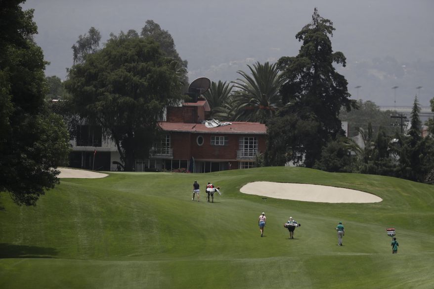 Caroline Masson, left, of Germany, and Cydney Clanton, third from left, of the U.S., walk toward the green on the 17th hole, during round two of the Lorena Ochoa Invitational at Mexico Golf Club in Mexico City, Friday, May 5, 2017. The invitational, the tenth of the 2017 LPGA tour, is the tour's first Match Play event since 2012. (AP Photo/Rebecca Blackwell)