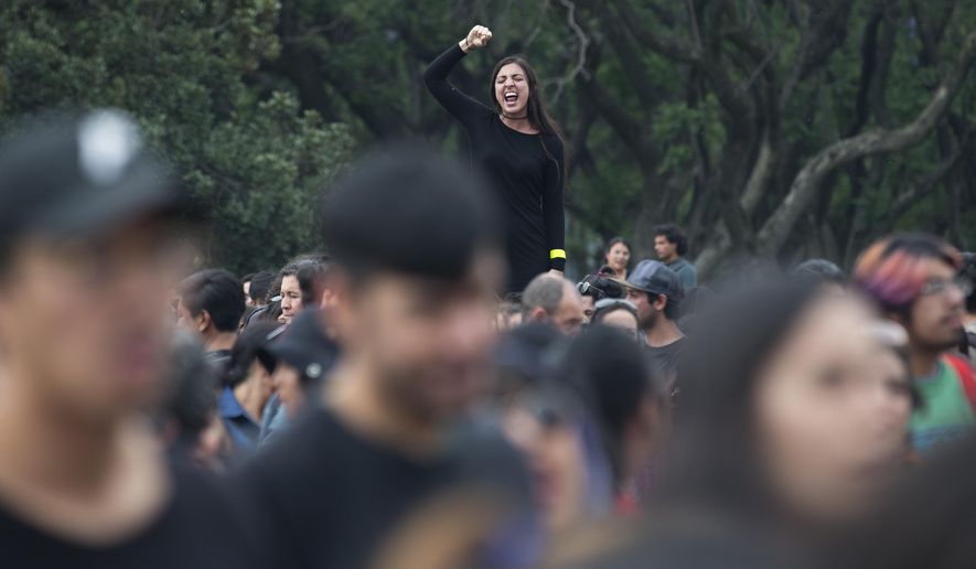 A woman shouts political slogans during a march at Mexico's National Autonomous University (UNAM) after a woman was found dead on campus in Mexico City, Friday, May 5, 2017. The woman's body was found on May 3 tied to a phone booth in the gardens next to UNAM's engineering school, according to a university statement. Her identity and cause of death were not immediately known. (AP Photo/Eduardo Verdugo)