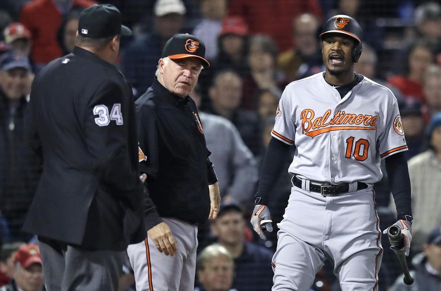 Baltimore Orioles' Adam Jones (10) yells at home plate umpire Sam Holbrook (34) after being ejected for arguing a strikeout during the fifth inning of a baseball game at Fenway Park in Boston, Wednesday, May 3, 2017. At center is Baltimore Orioles manager Buck Showalter. (AP Photo/Charles Krupa)
