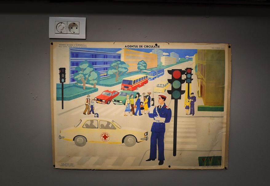 In this Thursday, May 4, 2017, photo a Communist education ministry poster depicting a traffic policeman is on display at the newly opened Bucharest Kitsch Museum, in Bucharest, Romania. The Kitsch Museum opens for visitors on Friday, May 5, 2017. (AP Photo/Vadim Ghirda)