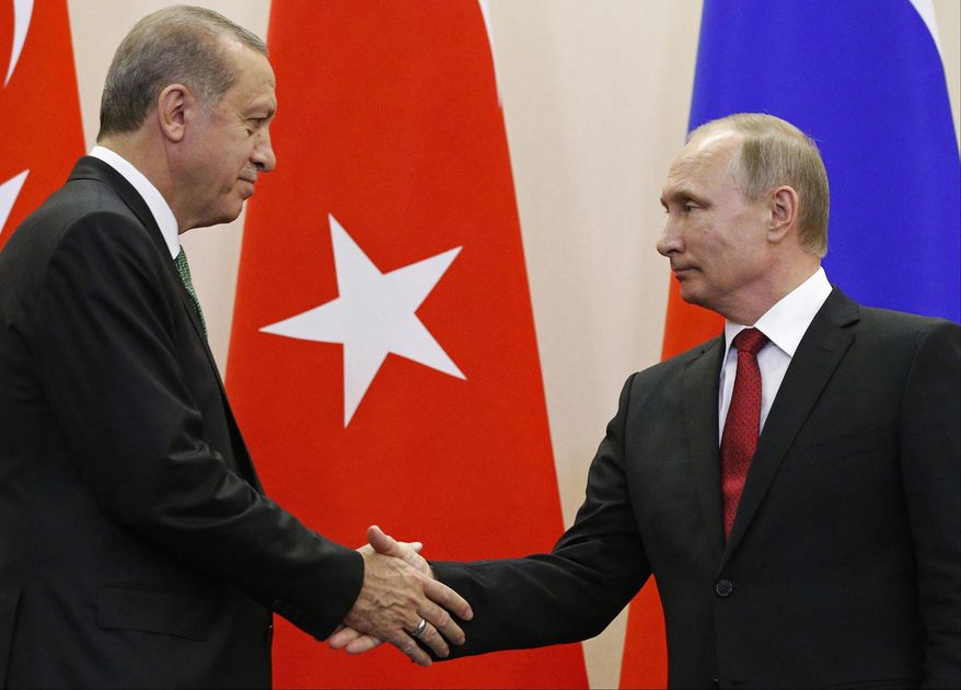 Russian President Vladimir Putin, right, and Turkish President Recep Tayyip Erdogan shake hands after a news conference following their talks in Putin's residence in the Russian Black Sea resort of Sochi, Russia, Wednesday, May 3, 2017. The presidents of Russia and Turkey are holding talks on the situation in Syria and also the restoration of full economic ties between their two countries. (AP Photo/Alexander Zemlianichenko, Pool)