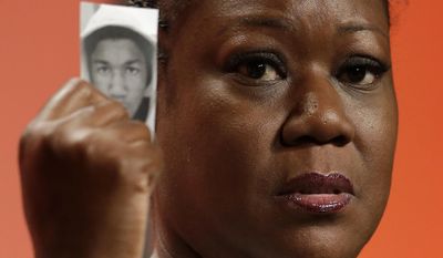 FILE - In this July 26, 2013, file photo, Sybrina Fulton, mother of Trayvon Martin, holds up a card with a photo of her son as she speaks at the National Urban League&#39;s annual conference in Philadelphia.  A university will award Martin a posthumous Bachelor of Science Degree in aviation five years after the black teenager was fatally shot by a neighborhood watch volunteer in a central Florida neighborhood. An announcement on Florida Memorial University&#39;s official Facebook page says Martin&#39;s parents, Fulton and Tracy Martin, will accept the degree during a May 13, 2017, commencement ceremony. Fulton graduated from the Miami Gardens university and, along with Tracy Martin, co-founded the Trayvon Martin Foundation.  (AP Photo/Matt Rourke, File)