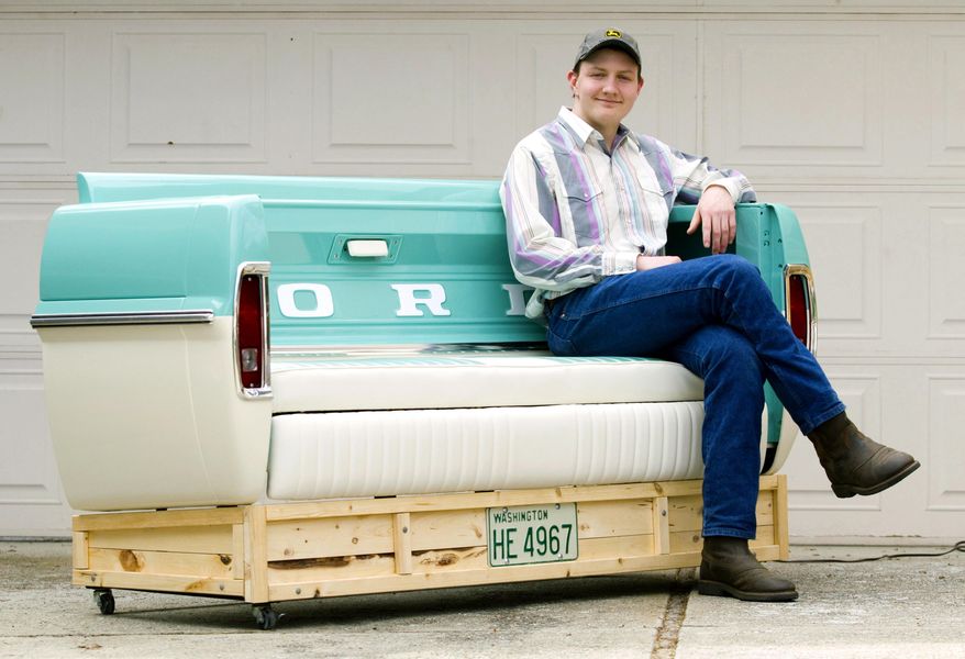 In this Tuesday, April 25, 2017 photo, Pullman High School senior Brandon Libey sits in his 1967 Ford bench outside his home in Pullman, Wash. Libey built the bench as his high school senior project with mentor Steve Myers, Jr. The bench was inspired by a 1967 Ford F-100 Libey's grandfather, Gary Beedy, owned. (Geoff Crimmins/The Moscow-Pullman Daily News via AP)