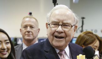 Warren Buffett, Berkshire Hathaway Chairman and CEO, smiles when presented with a talking Warren doll made by Genius Brands International, as he tours the exhibit floor at the CenturyLink Center in Omaha, Neb., Saturday, May 6, 2017, where company subsidiaries display their products. (AP Photo/Nati Harnik) ** FILE **