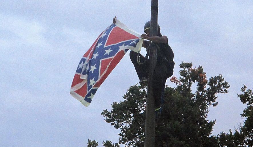 FILE - In this June, 27, 2015 file photo, Bree Newsome, of Charlotte, N.C., removes the Confederate flag from a Confederate monument at the Statehouse in Columbia, S.C. Newsome was taken into custody when she came down. A new generation of black women is moving to take and keep a place at the forefront of the fight against racial bias. Black women have not been strangers to past protests. But historians say they have often been overshadowed, first by white women during the suffragette movement and then by the black men who were lionized during the civil rights movement. (AP Photo/Bruce Smith, File)