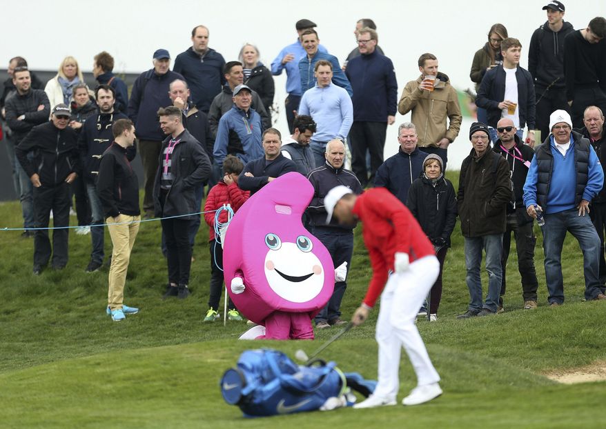 A mascot is displayed as Denmark's Lucas Bjerregaard prepares to make a shot, during day one of the Golf Sixes at the Centurion Club, in St Albans, England, Saturday May 6, 2017. The European Tour rolls out its latest innovative tournament, the six-hole GolfSixes event featuring two-man teams from 16 different countries. (Steven Paston/PA via AP)
