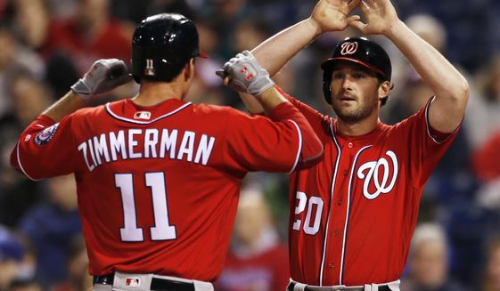 Washington Nationals Ryan Zimmerman (11) is cheered by Daniel Murphy (20) at home plate after he hit a two run home run off Philadelphia Phillies starting pitcher Vince Velasquez (28) in the fourth inning of a baseball game, Saturday, May 6, 2017, in Philadelphia. (AP Photo/Laurence Kesterson)