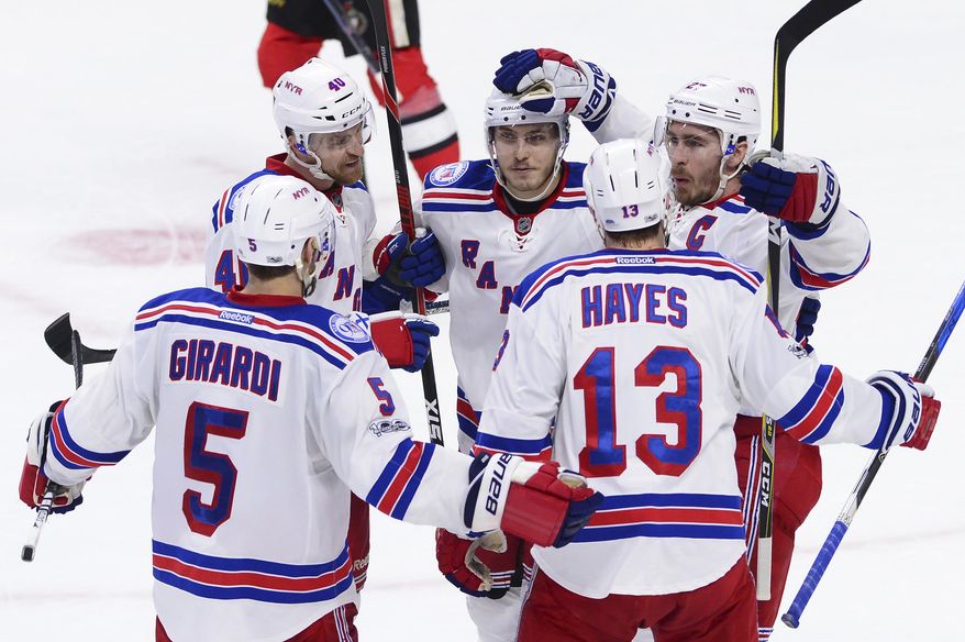 New York Rangers defenseman Ryan McDonagh (27) celebrates his goal with defenseman Dan Girardi (5) right wing Kevin Hayes (13) right wing Michael Grabner (40) and right wing Jesper Fast (19) during the second period against the Ottawa Senators in Game 5 in the second-round of the NHL hockey Stanley Cup playoffs in Ottawa on Saturday, May 6, 2017. (Sean Kilpatrick/The Canadian Press via AP)
