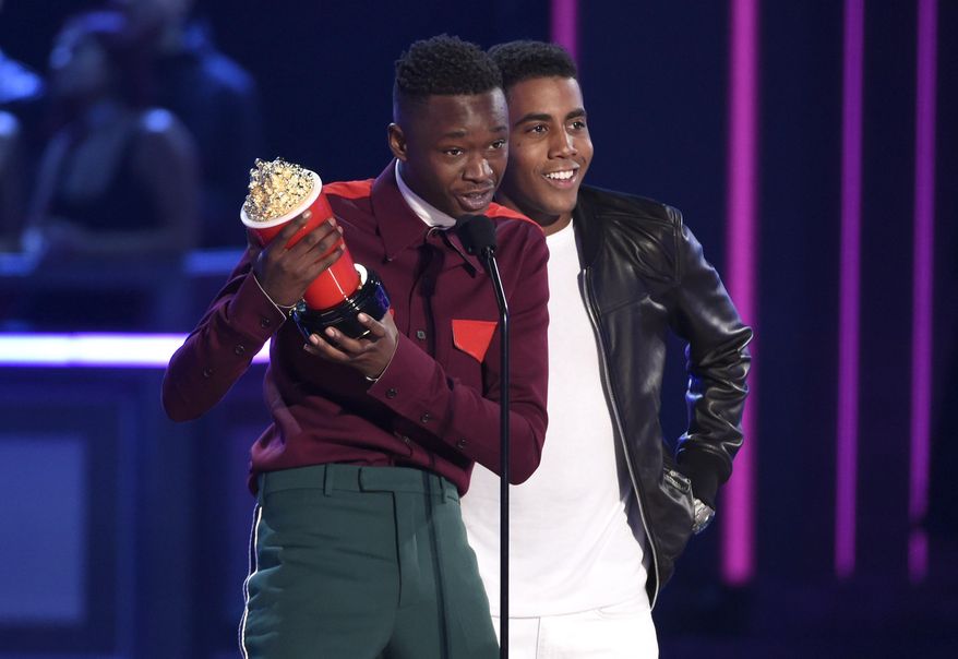 Ashton Sanders, left, and Jharrel Jerome accept the award for best kiss from "Moonlight" at the MTV Movie and TV Awards at the Shrine Auditorium on Sunday, May 7, 2017, in Los Angeles. (Photo by Chris Pizzello/Invision/AP)