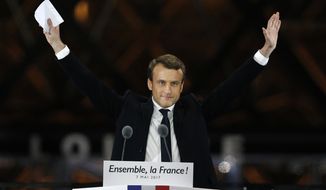 French President-elect Emmanuel Macron gestures during a victory celebration outside the Louvre museum in Paris, France, Sunday, May 7, 2017. Speaking to thousands of supporters from the Louvre Museum&#39;s courtyard, Macron said that France is facing an &quot;immense task&quot; to rebuild European unity, fix the economy and ensure security against extremist threats. (AP Photo/Thibault Camus)