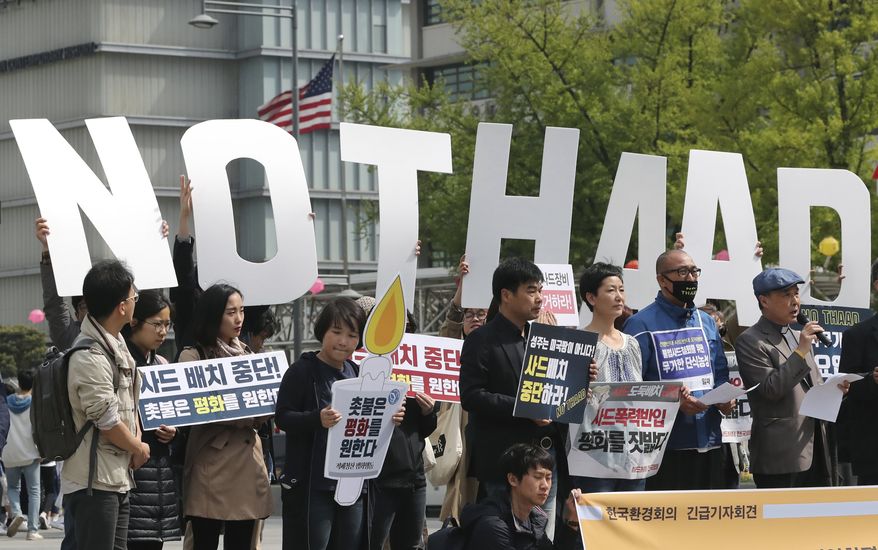 FILE - In this Friday, April 28, 2017, file photo, South Koreans hold cardboard letters reading &quot;NO THAAD&quot; during a rally to oppose a plan to deploy an advanced U.S. missile defense system called Terminal High-Altitude Area Defense, or THAAD, near the U.S. Embassy in Seoul, South Korea. Creating jobs, ending corruption and boosting low birthrates should be high on a to-do list for South Korea’s next president after a campaign mostly dominated by security and foreign policy issues. There is concern that the economy will likely take a backseat to North Korea when South Koreans pick their next leader on Tuesday, May 9. (AP Photo/Lee Jin-man, File)