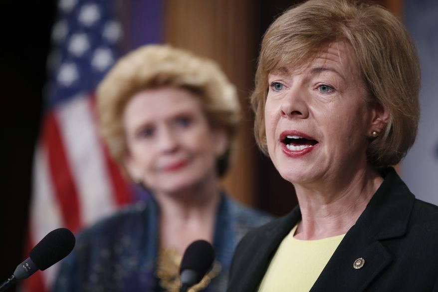 Sen. Tammy Baldwin (right), Wisconsin Democrat, accompanied by Sen. Debbie Stabenow, Michigan Democrat, speaks on Capitol Hill in Washington during a April 25, 2017, news conference to discuss President Donald Trump's first 100 days. (Associated Press) **FILE**