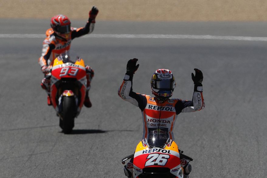 MotoGP rider Dani Pedrosa of Spain, right, celebrates his win as Marc Marquez of Spain follows behind to come second at the Spanish Motorcycle Grand Prix at the Jerez racetrack in Jerez de la Frontera, Spain, Sunday, May 7, 2017. (AP Photo/Miguel Morenatti)