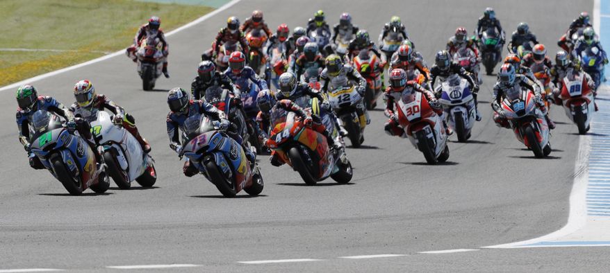 Moto2 rider Alex Marquez of Spain (number 73) rides into the first curve with the pack on his way to a win at the Spanish Motorcycle Grand Prix at the Jerez racetrack in Jerez de la Frontera, Spain, Sunday, May 7, 2017. (AP Photo/Miguel Morenatti)