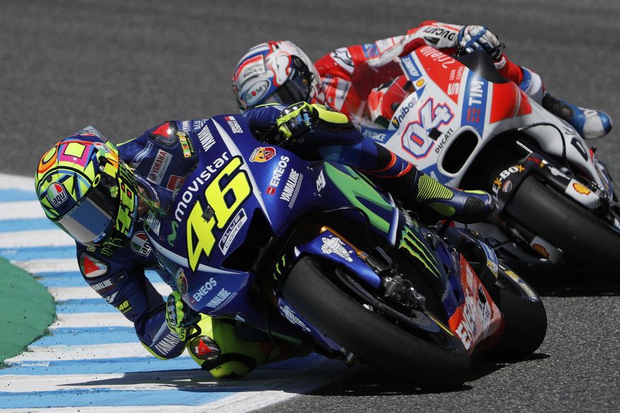 MotoGP rider Valentino Rossi of Italy rides ahead of Andrea Dovizioso of Italy at the Spanish Motorcycle Grand Prix at the Jerez racetrack in Jerez de la Frontera, Spain, Sunday, May 7, 2017. (AP Photo/Miguel Morenatti)