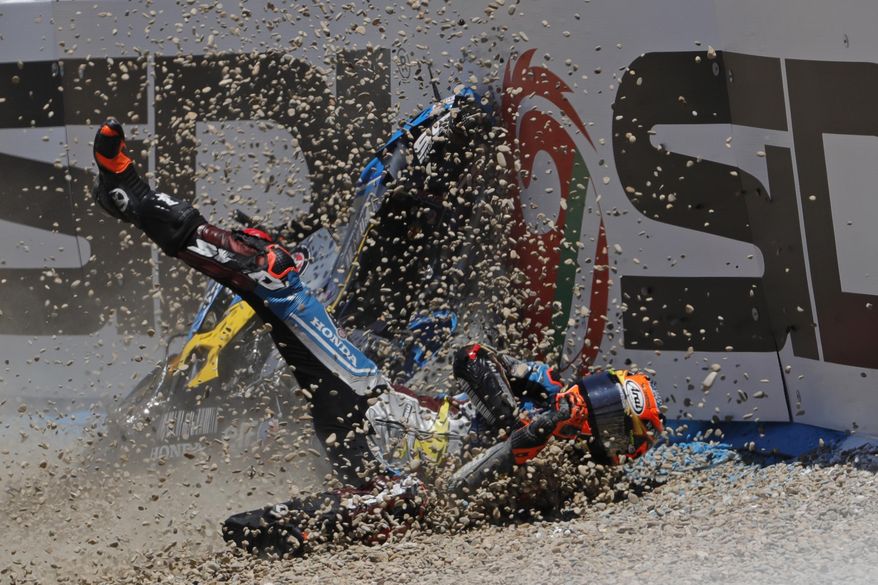 MotoGP rider Tito Rabat of Spain falls from his bike at the Spanish Motorcycle Grand Prix at the Jerez racetrack in Jerez de la Frontera, Spain, Sunday, May 7, 2017. (AP Photo/Miguel Morenatti)