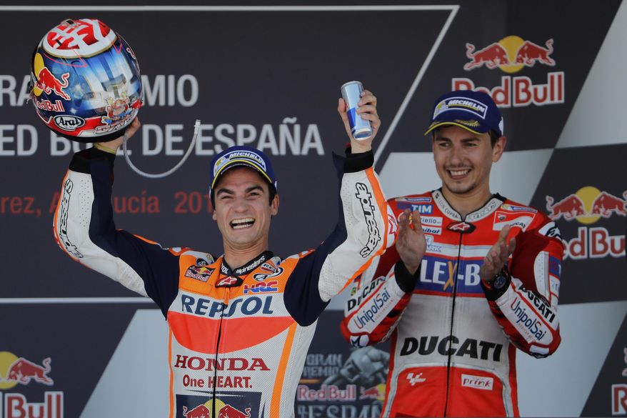 Third placed MotoGP rider Jorge Lorenzo of Spain, right, applauds as MotoGP race winner Dani Pedrosa of Spain celebrates at the Spanish Motorcycle Grand Prix at the Jerez racetrack in Jerez de la Frontera, Spain, Sunday, May 7, 2017. (AP Photo/Miguel Morenatti)