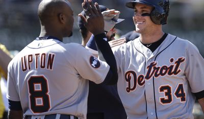 Detroit Tigers&#x27; James McCann, right, celebrates with Justin Upton (8) after hitting a two run home run off Oakland Athletics&#x27; Ryan Dull in the sixth inning of a baseball game, Sunday, May 7, 2017, in Oakland, Calif. (AP Photo/Ben Margot)