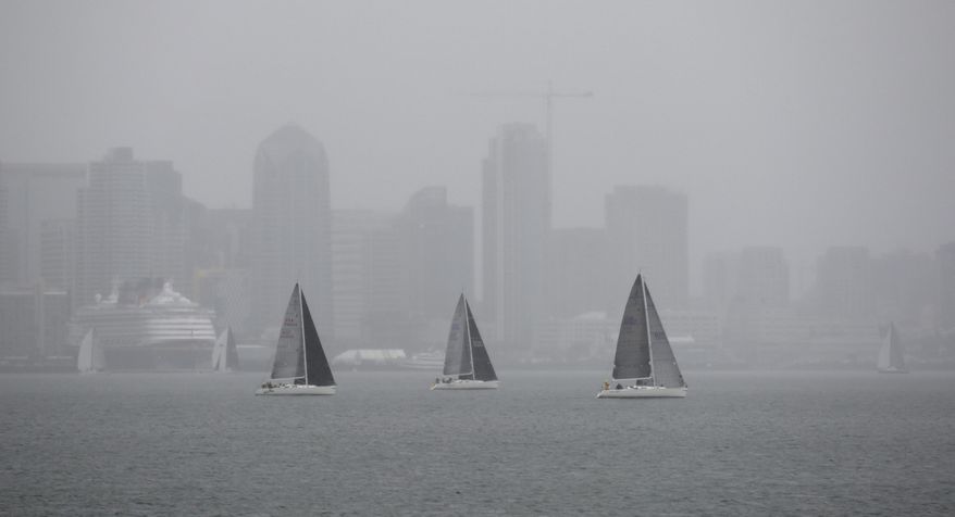 Sailors competing in the Yachting Cup, put on by San Diego Yacht Club, battle the elements as heavy rain comes down in San Diego Bay on Sunday, May 7, 2017. A spring storm hit Southern California on Sunday with gusty winds, thunderstorms and pea-size hail stones, prompting everything from the cancellation of a baseball game to the sight of celebrities at a red-carpet ceremony scrambling for cover. (K.C. Alfred/The San Diego Union-Tribune via AP)