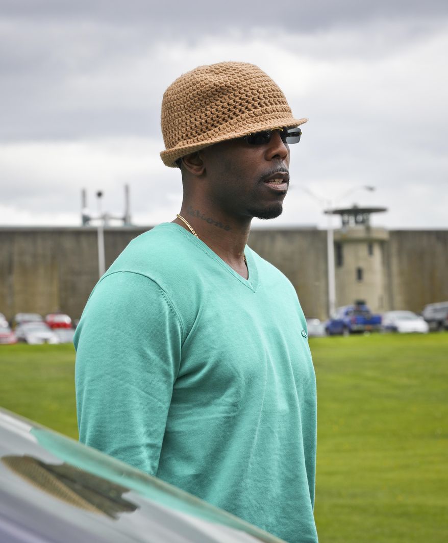 Calvin Buari stands outside Green Haven correctional facility, shown in background, shortly after his release, Monday May 8, 2017, in Stormville, N.Y. Buari, who spent 22 years in prison for a double killing he said he didn't do, was freed after his conviction was overturned.(AP Photo/Bebeto Matthews)