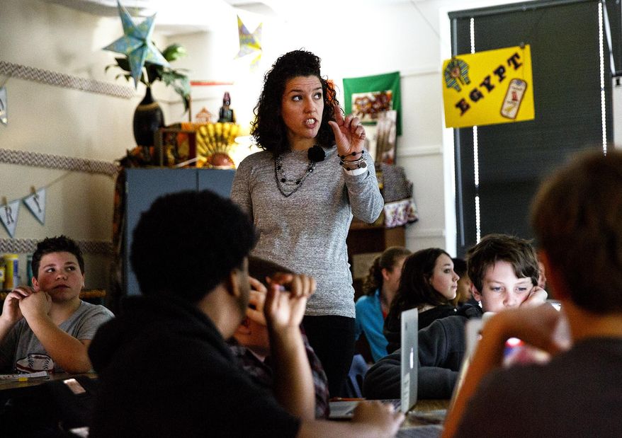 In this April 5, 2017 photo, Lincoln Magnet School teacher Layne Zimmers teaches sixth- grade world history at the school in Springfield, Ill. Zimmers has been chosen as a 2017 Lindblad Expeditions and National Geographic Grosvenor Teacher Fellow. Later this year she'll study the unique wildlife of the Galapagos Island with Lindblad-National Geographic expedition experts. (Rich Saal/The State Journal-Register via AP)Journal-Register via AP)