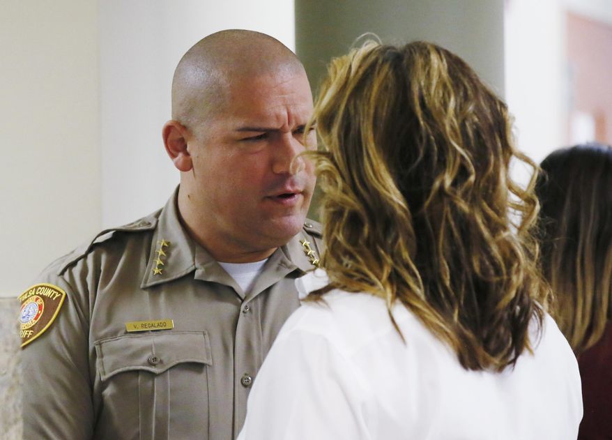 Tulsa County Sheriff Vic Regalado, left, talks with Shannon McMurray, right, defense attorney for Tulsa officer Betty Shelby, before the start of jury selection in Shelby's trial in Tulsa, Okla., Monday, May 8, 2017. Shelby is charged with manslaughter in the shooting of Terence Crutcher, an unarmed black man. (AP Photo/Sue Ogrocki)