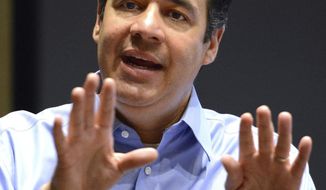 U.S. Congressman Raul R. Labrador keeps a calm demeanor as he answers a question even with boos from the crowd at Lewis-Clark State College, Friday, May 5, 2017, in Lewiston, Idaho. (Kyle Mills/Lewiston Tribune via AP)