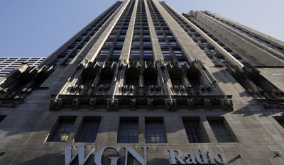 FILE - In this Monday, May 1, 2017, file photo, the WGN Radio sign appears on the side of Tribune Tower, in downtown Chicago. Sinclair Broadcast Group, one of the nation&#39;s largest local TV station operators, announced Monday, May 8, 2017, that it will pay about $3.9 billion for Tribune Media, adding more than 40 stations including KTLA in Los Angeles, WPIX in New York and WGN in Chicago. (AP Photo/Kiichiro Sato, File)
