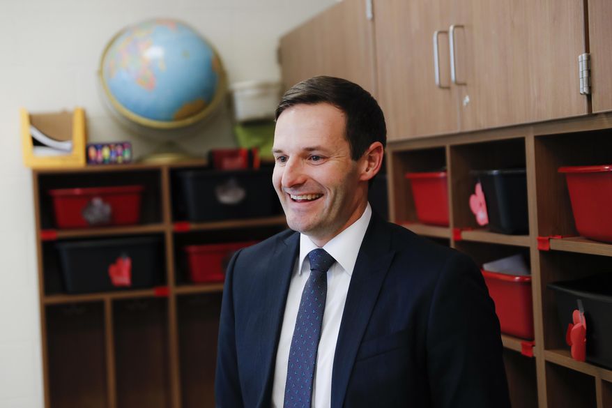 In this Wednesday, March 29, 2017, photo, Circleville City Schools Superintendent Jonathan Davis looks on as students are helped with their homework during an after-school program at Circleville Elementary School, in Circleville, Ohio. After-school support was a driving factor in raising the district’s graduation rate from 79 percent in 2008 to about 94 percent last year, Davis said. (AP Photo/John Minchillo)