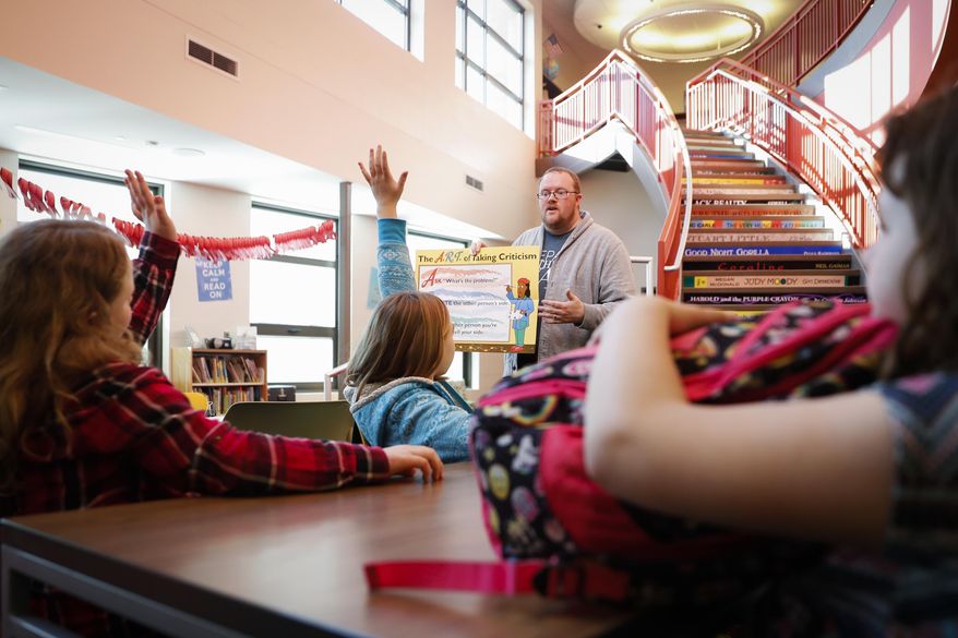 In this Wednesday, March 29, 2017 photo, Jeff Parker, a prevention specialist from Pickaway Area Recovery Services talks to students during an after-school program at Circleville Elementary School, in Circleville, Ohio. This after-school enrichment is funded largely by the federal 21st Century Community Learning Centers, a $1.2 billion program serving about 1.6 million low-income kids nationwide that President Donald Trump proposes eliminating. (AP Photo/John Minchillo)
