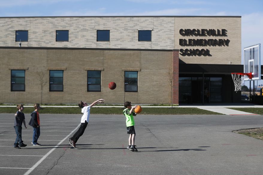 In this Wednesday, March 29, 2017, photo, students play during an after-school program at Circleville Elementary School, in Circleville, Ohio. Supporters of after-school programs in places like Circleville, and Concord, N.H., said the study help, social skill-building and supervision they provide is at stake if President Donald Trump’s administration cuts the main federal funding for such programs. (AP Photo/John Minchillo)