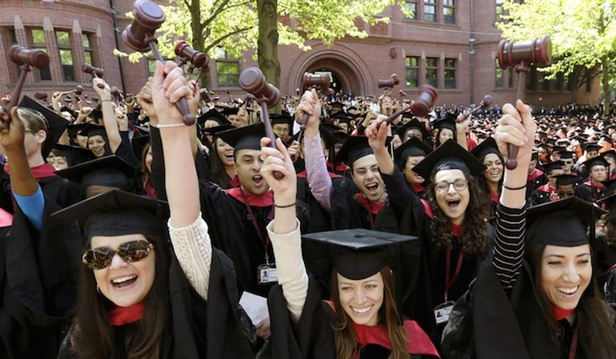 Graduates of Harvard Law School wave gavel during commencement ceremonies on May 29, 2014, in Cambridge, Mass. (Associated Press) ** FILE **