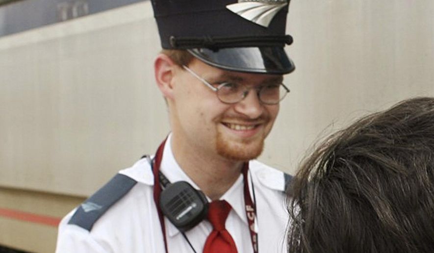 This Aug. 21, 2007, file photo shows Amtrak assistant conductor Brandon Bostian outside a train at the Amtrak station in St. Louis. (Huy Richard Mach/St. Louis Post-Dispatch via AP, File)