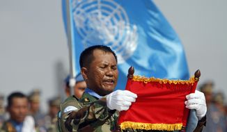 FILE - In this April 7, 2015, file photo, A Cambodian soldier who leads a troop takes the oath of the United Nations mission in Mali and South Sudan in Africa during a send-off ceremony for the Cambodian military personnel at the Royal Cambodian Air Force in Phnom Penh, Cambodia. Attackers in Central African Republic, the western neighbor nation of South Sudan, ambushed a convoy of U.N. peacekeepers, killing one Cambodian soldier and wounding another, Cambodia&#39;s prime minister said Tuesday, May 9, 2017. (AP Photo/Heng Sinith, File)