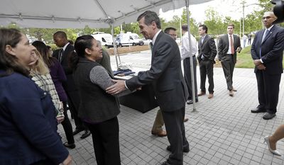 North Carolina Gov. Roy Cooper greets Credit Suisse employees following a news conference at Credit Suisse in Morrisville, N.C., Tuesday, May 9, 2017. Credit Suisse plans to add up to 1,200 jobs at its North Carolina technology hub. The jobs projection comes five weeks after North Carolina partially repealed a state law limiting LGBT rights. (AP Photo/Gerry Broome)