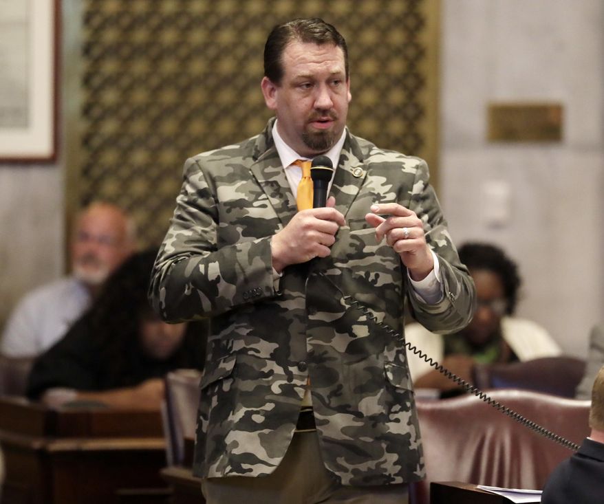 Rep. Jeremy Faison, R-Cosby, wears a camouflage jacket as he speaks during a House session Tuesday, May 9, 2017, in Nashville, Tenn. (AP Photo/Mark Humphrey)