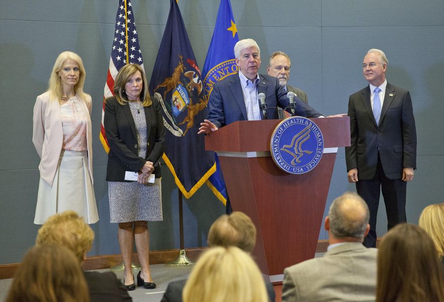Gov. Rick Snyder, middle, speaks at the George W. Romney Building in Lansing, Mich., on Tuesday, May 9, 2017. The press conference highlighted President Donald J. Trump's opioid awareness policy. Also pictured are Kellyanne Conway,left, an advisor to President Trump; Macomb County Judge Linda Davis, who is also president of Families Against Narcotics; Mike Hirst, an advocate for victims of drug addiction; and U.S. Secretary of Health and Human Services Tom Price, right. (Cory Morse /The Grand Rapids Press via AP)