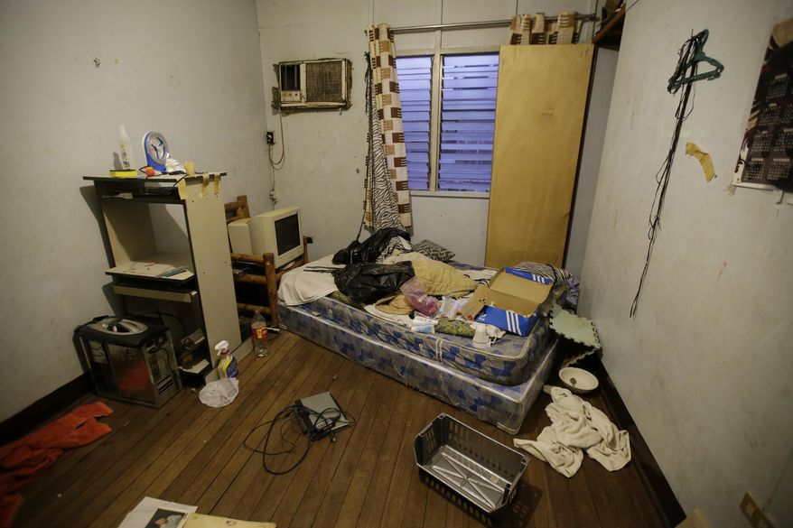 In this April 20, 2017, photo, a room inside the home of suspected child webcam cybersex operator, David Timothy Deakin, from Peoria, Ill., during a raid in Mabalacat, Philippines. Children's underwear, toddler shoes, cameras, bondage cuffs, fetish ropes, meth pipes, stacks of hard drives and photo albums cluttered the stuffy, two-bedroom townhouse. In his computer files, there were videos and images of young boys and girls engaged in sex acts. (AP Photo/Aaron Favila)