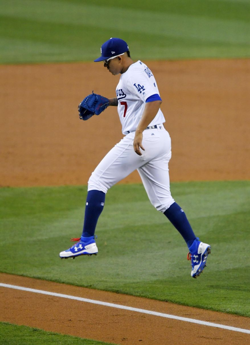 Los Angeles Dodgers starting pitcher Julio Urias jumps over the baseline on the way to the dugout after the top of the second inning of the team's baseball game against the Pittsburgh Pirates, Tuesday, May 9, 2017, in Los Angeles. (AP Photo/Mark J. Terrill)