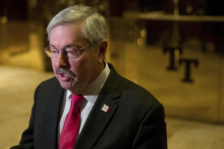 FILE - In this Dec. 6, 2016 file photo, Iowa Gov. Terry Branstad speaks to members of the media in the lobby of Trump Tower in New York. A Senate panel has approved Branstad as U.S. ambassador to China. (AP Photo/Andrew Harnik, File)