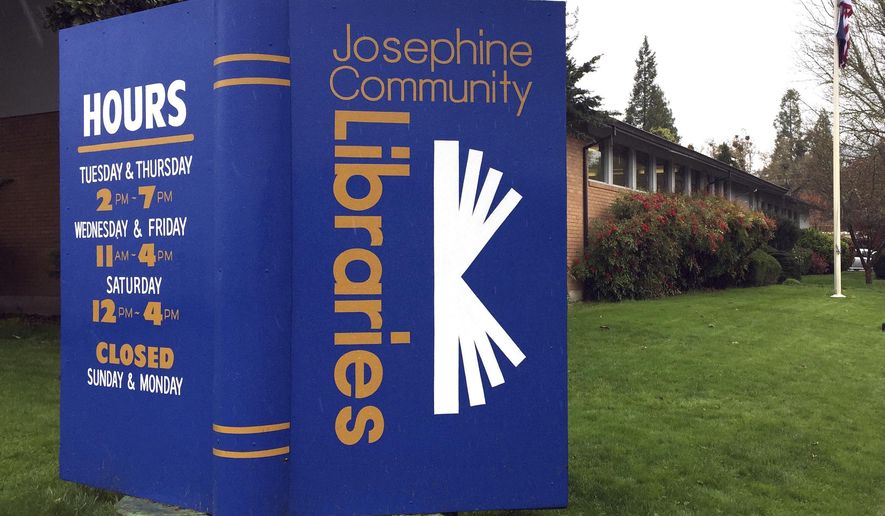 In this April 7, 2017, photo, a large display stands in the lawn of the main Josephine County library branch in Grants Pass, Ore. The library system in Josephine County has been operating as a nonprofit on donations and volunteer hours since it lost public funding, but a measure on the May 16 ballot could restore limited tax dollars by creating a special library tax district. (AP Photo/Gillian Flaccus)