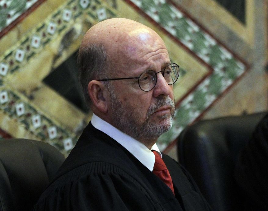 FILE - In this Dec. 6, 2010 file photo, Senior Circuit Judge Michael Daly Hawkins hears arguments during a hearing in the Ninth Circuit Court of Appeals in San Francisco, Calif . Daly Hawkins is one of three judges appointed by President Bill Clinton that will hear the Trump administration's appeal of Hawaii's so-far successful challenge to the president's travel ban that targets six predominantly Muslim countries. (AP Photo/Eric Risberg, Pool, file)