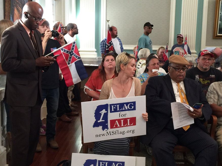 Supporters and opponents of the Mississippi flag fill Biloxi City Council chambers on Tuesday, May 9, 2017, as council members debate whether to pass a resolution requiring the flag fly at city buildings. Mayor Andrew “FoFo” Gillich ordered the banner removed from display at city buildings in late April, saying he wants tourists to feel welcome. (Mary Perez/The Sun Herald via AP)